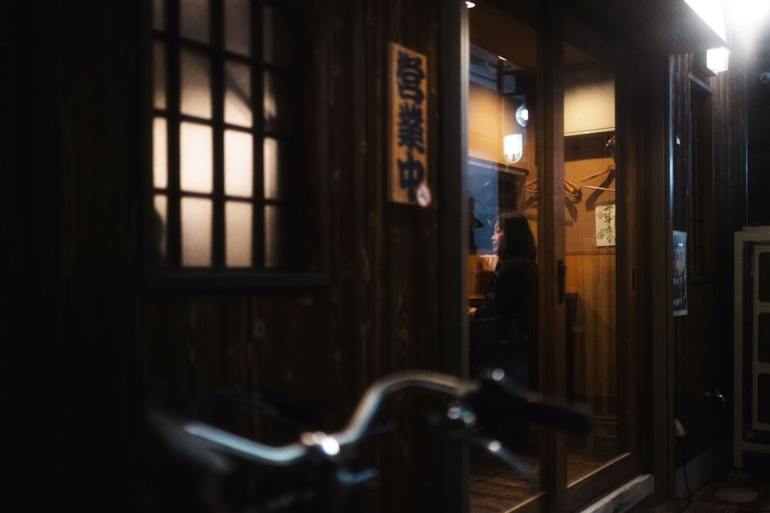 A bike parked in front of a doorway at night