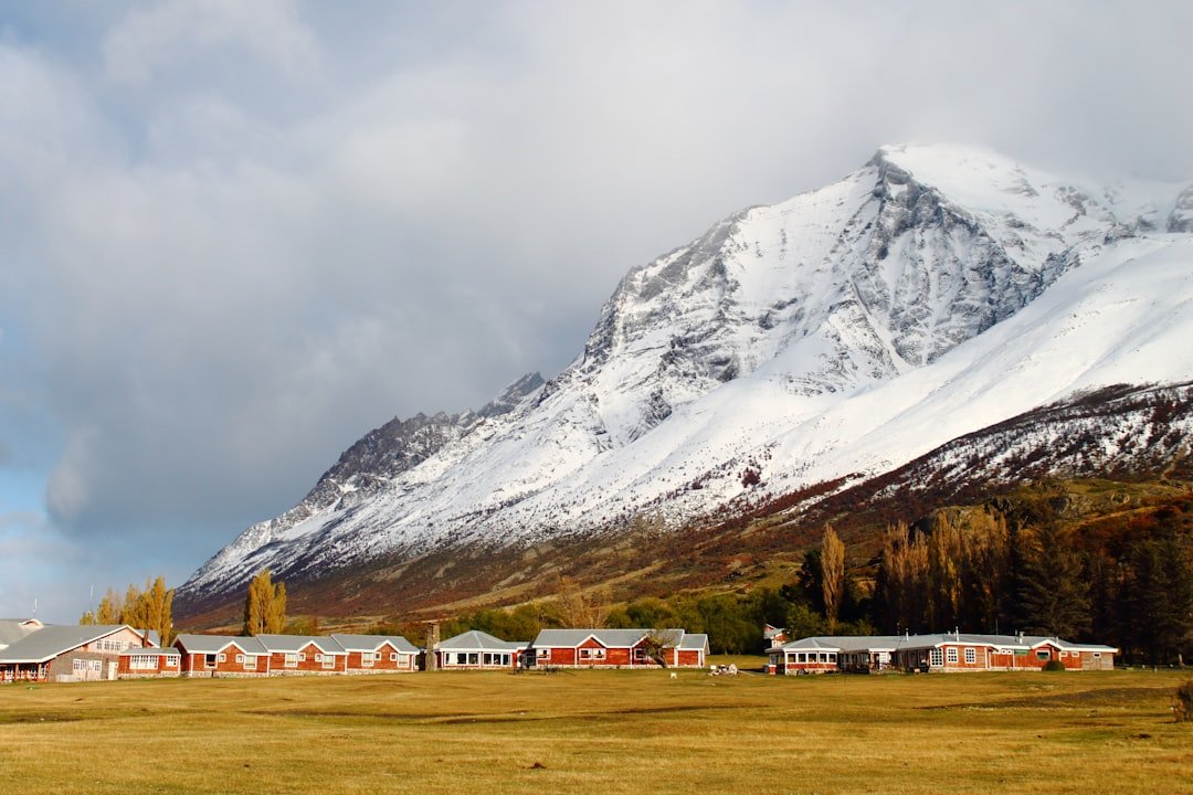 a group of buildings in front of a mountain