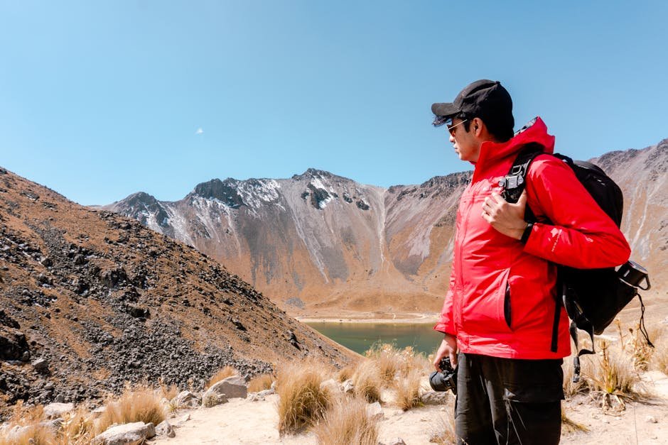 Man in red jacket hiking near Toluca's Nevado de Toluca crater lake, Méx., México