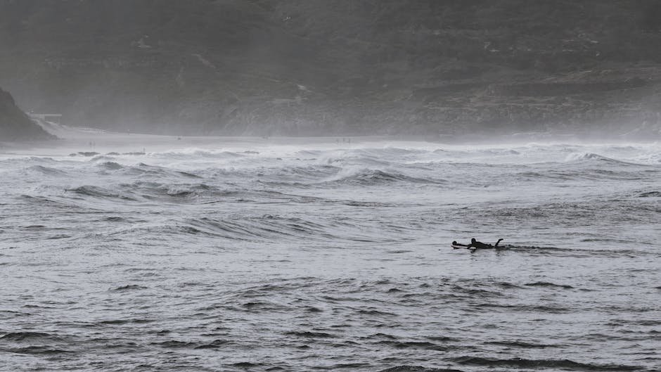 Surfers ride the dynamic waves of Ericeira Beach in Portugal, showcasing adventure in nature.