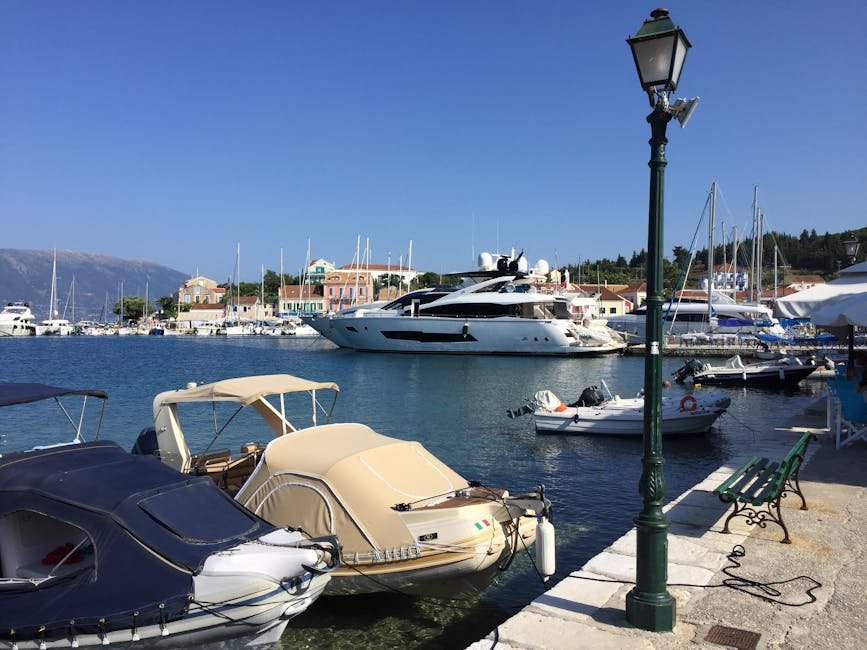 Picturesque yachts docked in the harbor of Fiskardo, Greece, under clear blue skies.